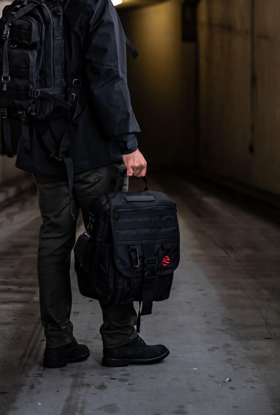 Man carrying black Business Backpack in hand.